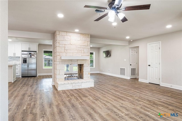 111 Warwick Glen St, Victoria, TX 77904 - unfurnished living room featuring wood finished floors, a ceiling fan, recessed lighting, and a fireplace