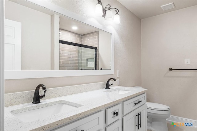 111 Warwick Glen St, Victoria, TX 77904 - full bathroom featuring double vanity, tiled shower, and a textured wall