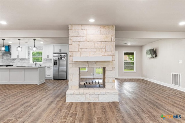 111 Warwick Glen St, Victoria, TX 77904 - unfurnished living room with wood finished floors, recessed lighting, and a stone fireplace