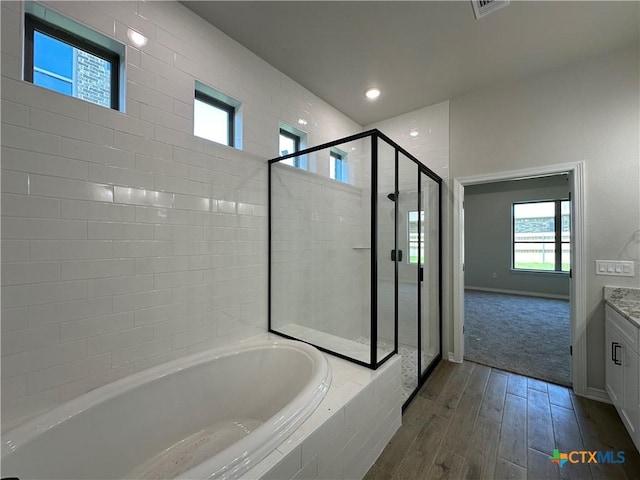 2032 Yarrow Rd, Temple, TX 76502 - bathroom with a bath, vanity, a shower stall, wood finished floors, and recessed lighting