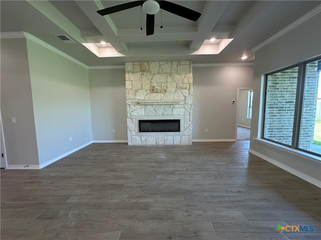 2032 Yarrow Rd, Temple, TX 76502 - unfurnished living room with plenty of natural light, ceiling fan, dark wood-type flooring, a fireplace, and crown molding