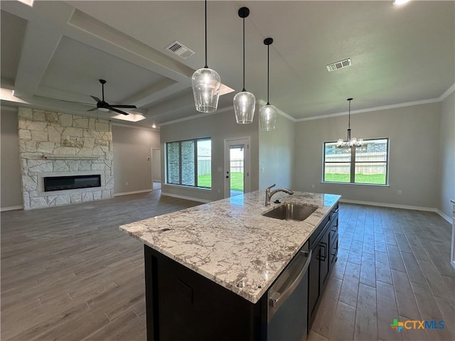 2032 Yarrow Rd, Temple, TX 76502 - kitchen featuring wood finished floors, ceiling fan, a fireplace, open floor plan, and stainless steel dishwasher