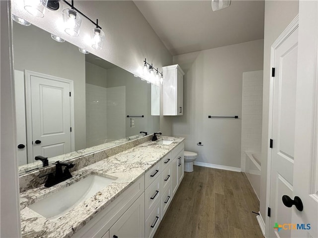 2032 Yarrow Rd, Temple, TX 76502 - full bathroom featuring wood finished floors, double vanity, and bathing tub / shower combination