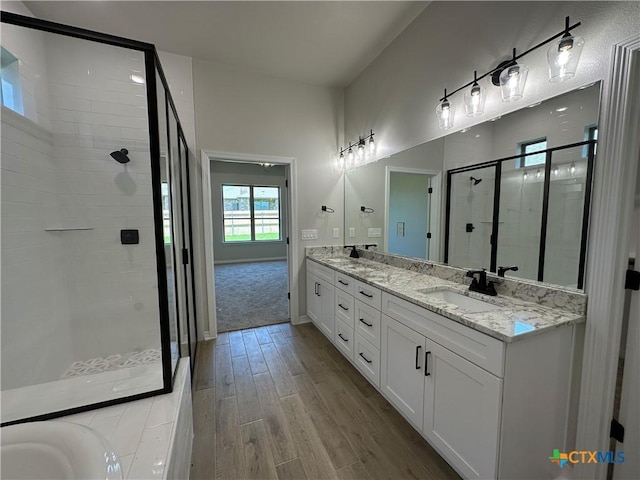2032 Yarrow Rd, Temple, TX 76502 - full bath featuring double vanity, a shower stall, and wood finished floors