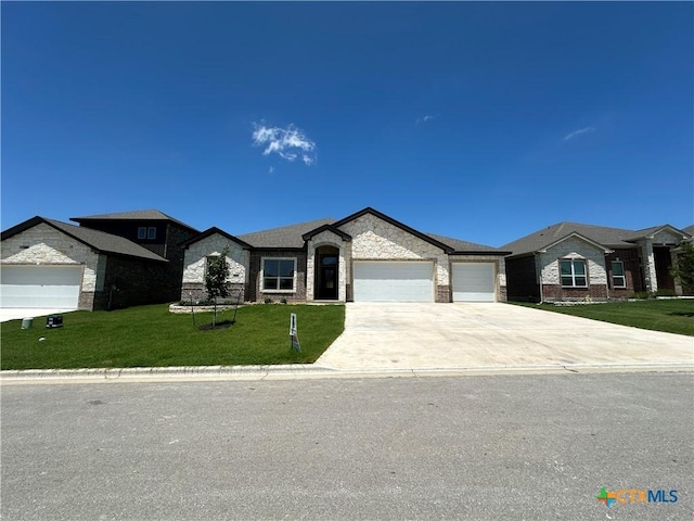 2032 Yarrow Rd, Temple, TX 76502 - view of front of home with a garage, driveway, a front yard, stone siding, and brick siding