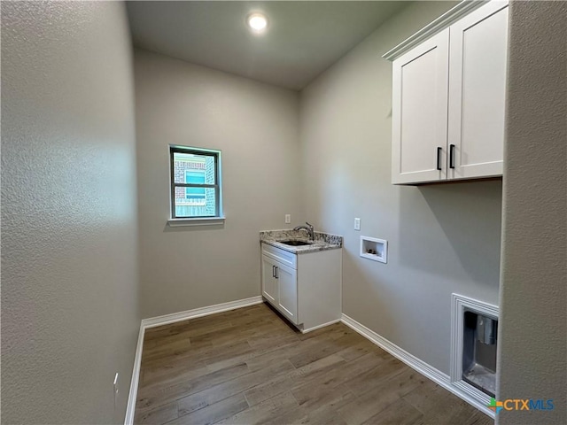 2032 Yarrow Rd, Temple, TX 76502 - washroom featuring cabinet space, washer hookup, and wood finished floors