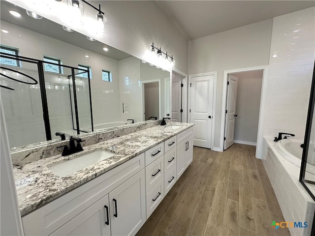 2032 Yarrow Rd, Temple, TX 76502 - bathroom featuring a garden tub, double vanity, wood finished floors, and a shower stall