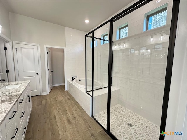 2032 Yarrow Rd, Temple, TX 76502 - bathroom with a bath, a stall shower, vanity, wood finished floors, and recessed lighting