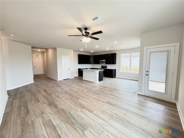 bathroom featuring vanity, lofted ceiling, hardwood / wood-style floors, and a shower with door