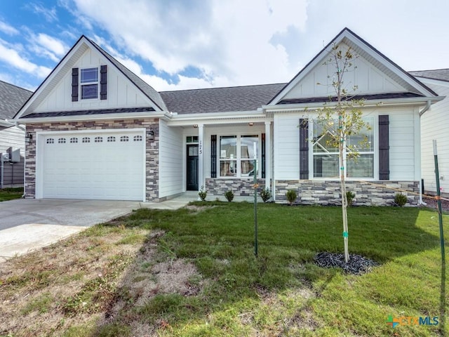 view of front of home with a garage and a front lawn