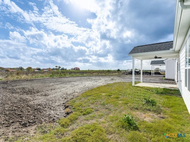 view of yard featuring ceiling fan