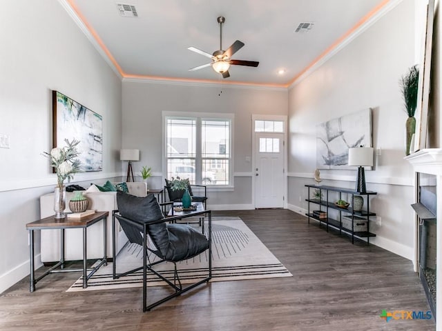 interior space featuring a fireplace, dark hardwood / wood-style flooring, ceiling fan, and crown molding