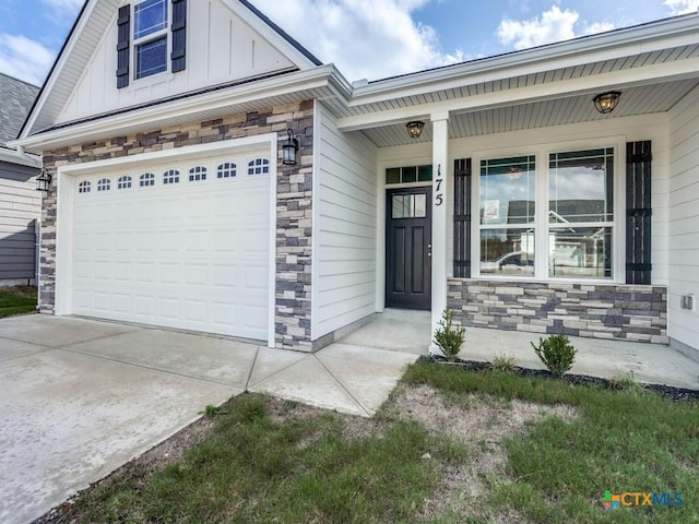 175 Lost Maples Way, Marion, TX 78124 - doorway to property featuring stone siding, board and batten siding, driveway, and covered porch