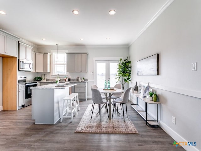 kitchen with gray cabinets, plenty of natural light, and stainless steel appliances