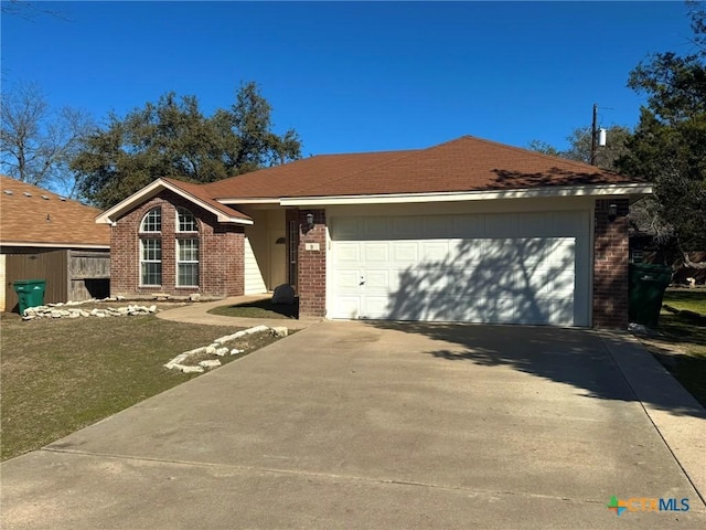 ranch-style house with a garage and a front lawn