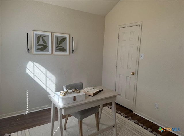 home office featuring baseboards, lofted ceiling, and dark wood-type flooring