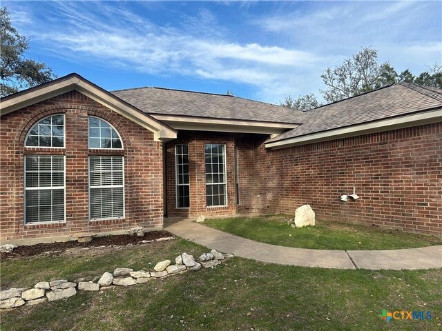 ranch-style home with a front yard and a garage