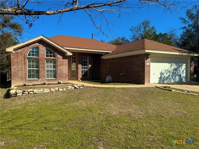 ranch-style house featuring a garage and a front yard