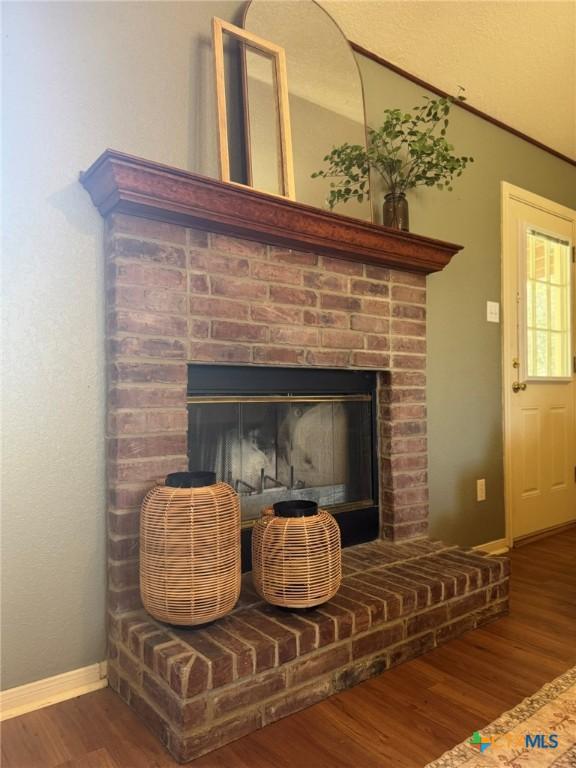 room details featuring hardwood / wood-style flooring and a fireplace