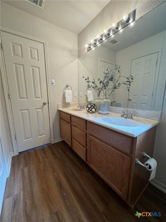 bathroom featuring vanity and hardwood / wood-style floors