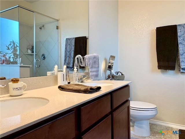 bathroom with a stall shower, a sink, toilet, and double vanity