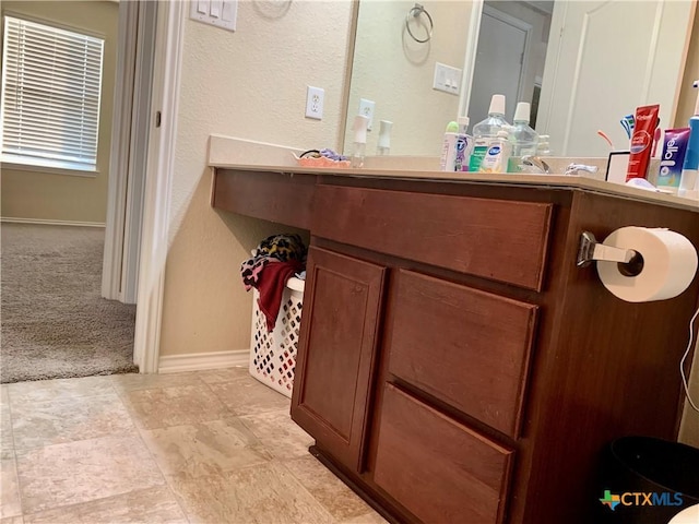 bathroom with baseboards and vanity