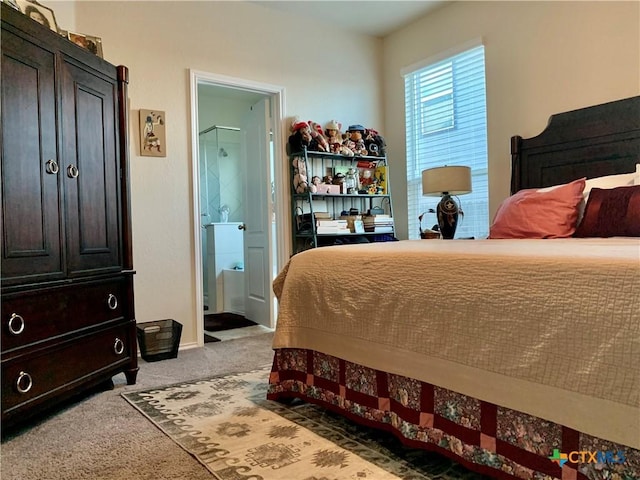 bedroom with carpet floors, connected bathroom, and baseboards