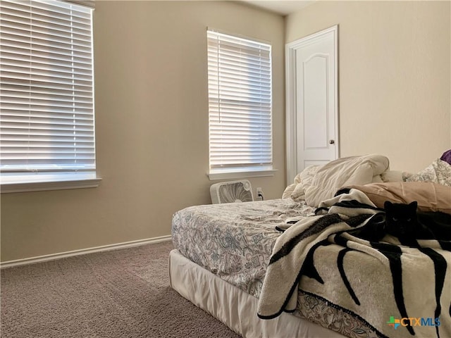 carpeted bedroom featuring baseboards