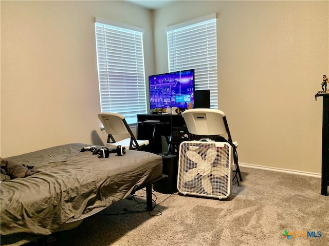 carpeted bedroom featuring baseboards