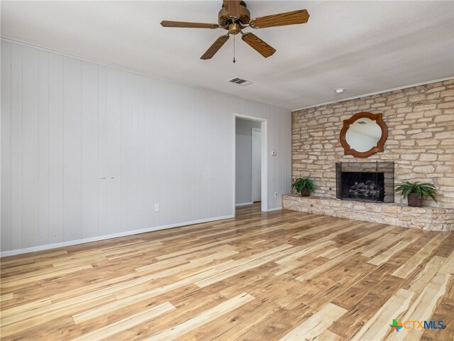 1304 Wroxton Way, Round Rock, TX 78664 - unfurnished living room featuring wood finished floors, ceiling fan, a fireplace, and ornamental molding