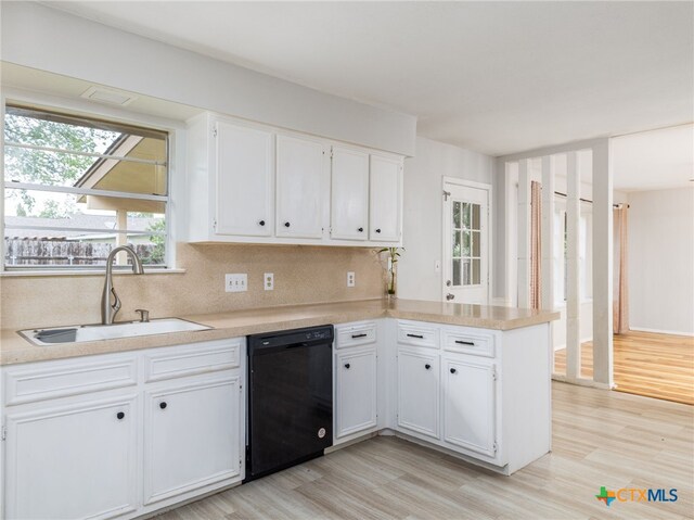 1304 Wroxton Way, Round Rock, TX 78664 - kitchen with black dishwasher, white cabinetry, light wood finished floors, a peninsula, and light countertops