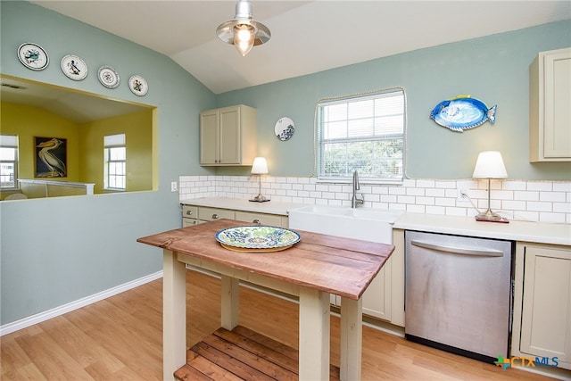 kitchen with sink, light hardwood / wood-style flooring, stainless steel dishwasher, backsplash, and lofted ceiling