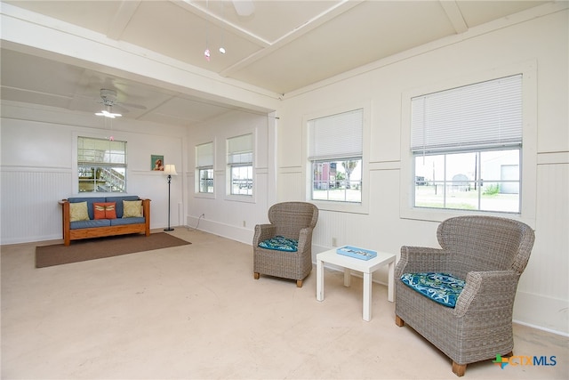 sitting room featuring ceiling fan and concrete floors