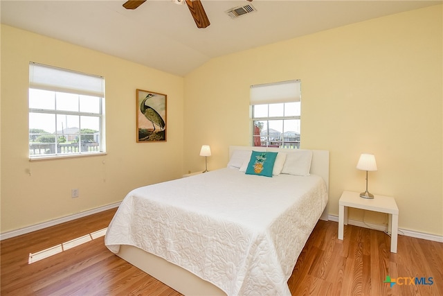 bedroom featuring light wood-type flooring, ceiling fan, and lofted ceiling