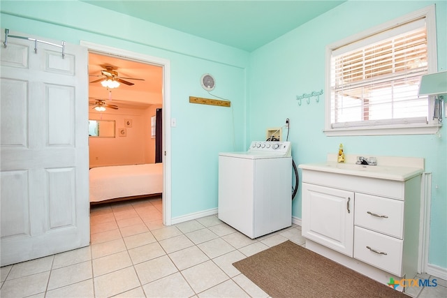 laundry room featuring washer / clothes dryer, sink, light tile patterned floors, and cabinets