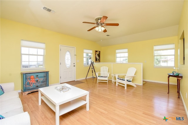 living room featuring hardwood / wood-style floors and ceiling fan