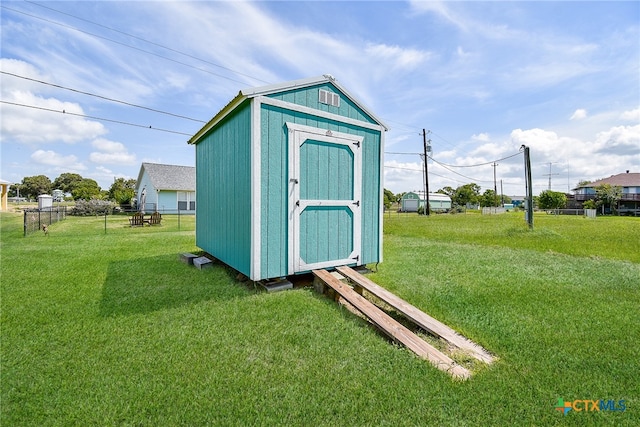 view of outbuilding with a lawn