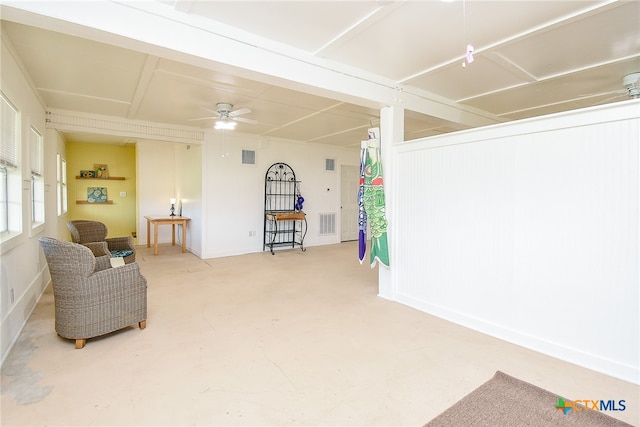 living area featuring concrete floors and ceiling fan