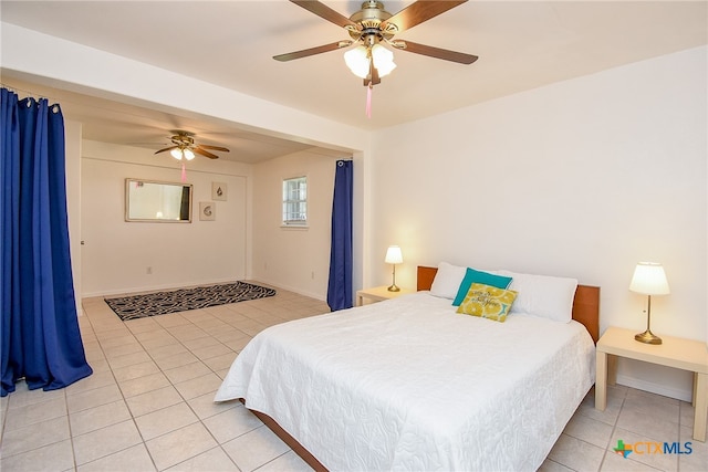 tiled bedroom featuring ceiling fan