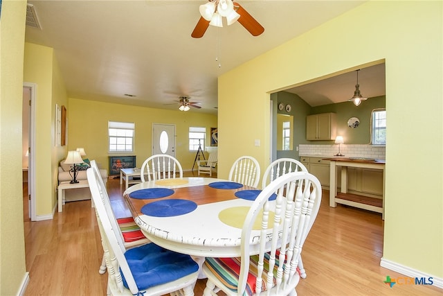 dining area with light hardwood / wood-style flooring and ceiling fan