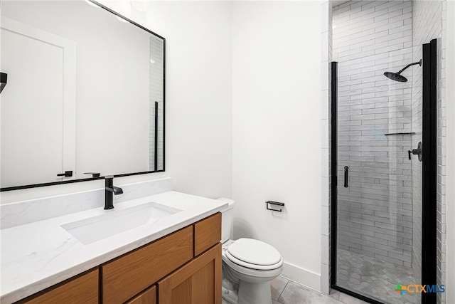 bathroom featuring toilet, vanity, tile patterned flooring, and a shower with door