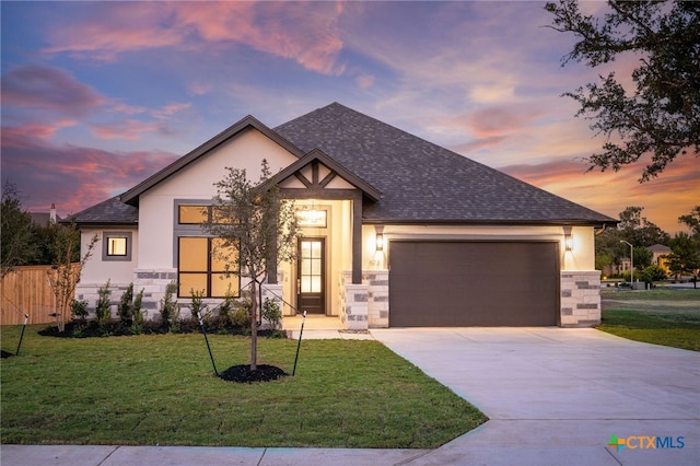 view of front of home with a lawn and a garage