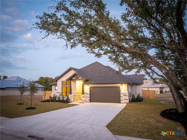 view of front of house featuring a lawn and a garage