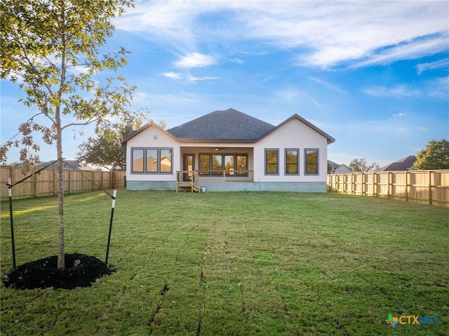 rear view of house with a lawn