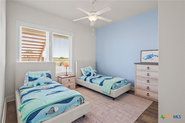 bedroom featuring ceiling fan and dark hardwood / wood-style floors