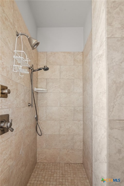 bathroom with a tile shower