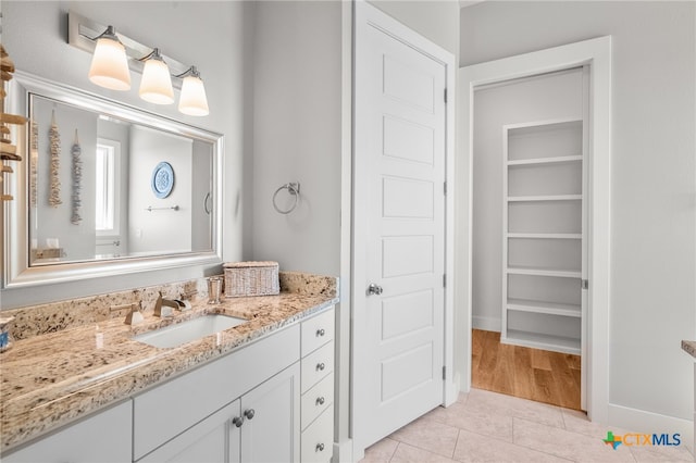 bathroom with tile patterned flooring and vanity