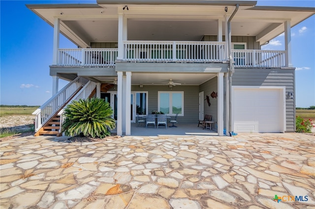 back of house featuring a patio area, a garage, and ceiling fan