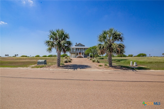 view of front of property with a rural view