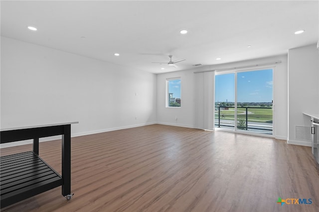 unfurnished room with ceiling fan and hardwood / wood-style flooring